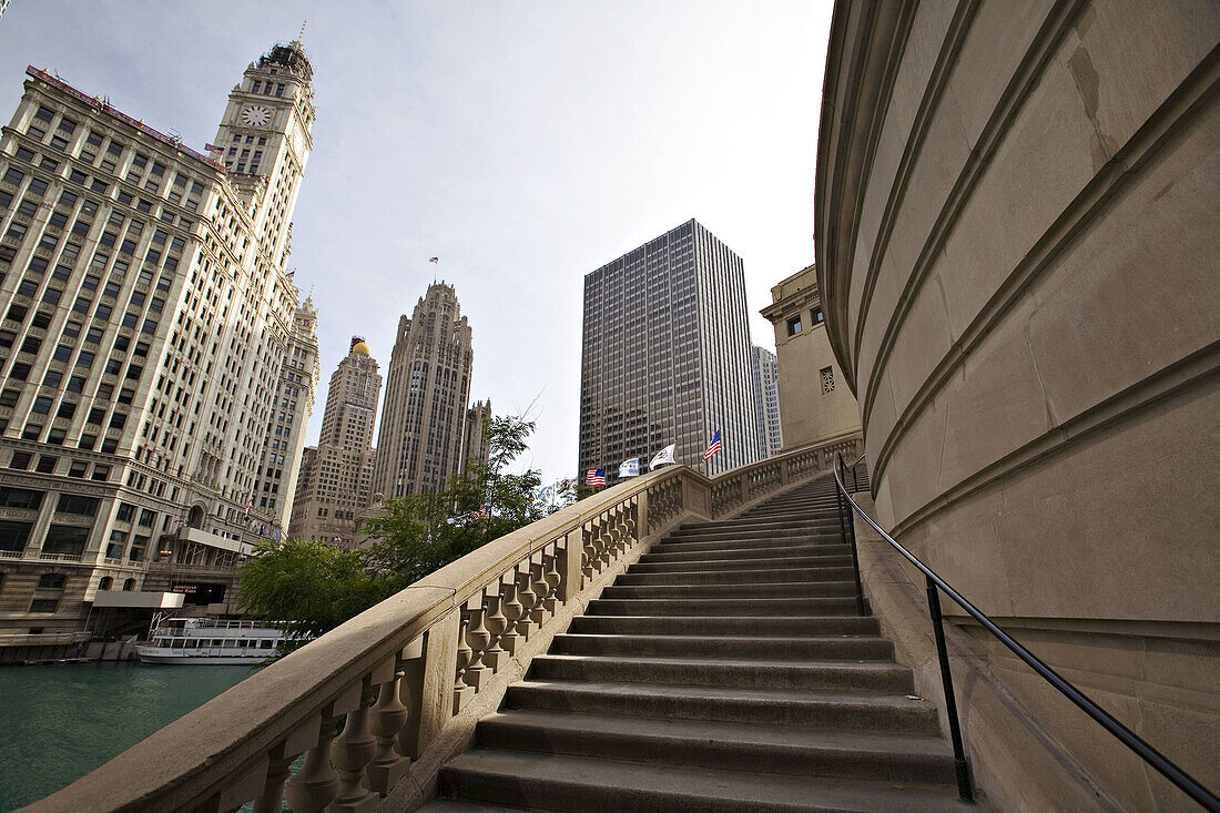 Illinois. Chicago. Curved stairway lead up to Michigan Avenue bridge over Chicago River, Wrigley Building and Tribune Tower