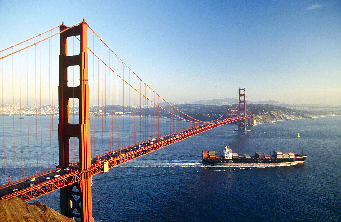 Cargo ship, headed to sea. Golden Gate Bridge. San Francisco, California. USA.