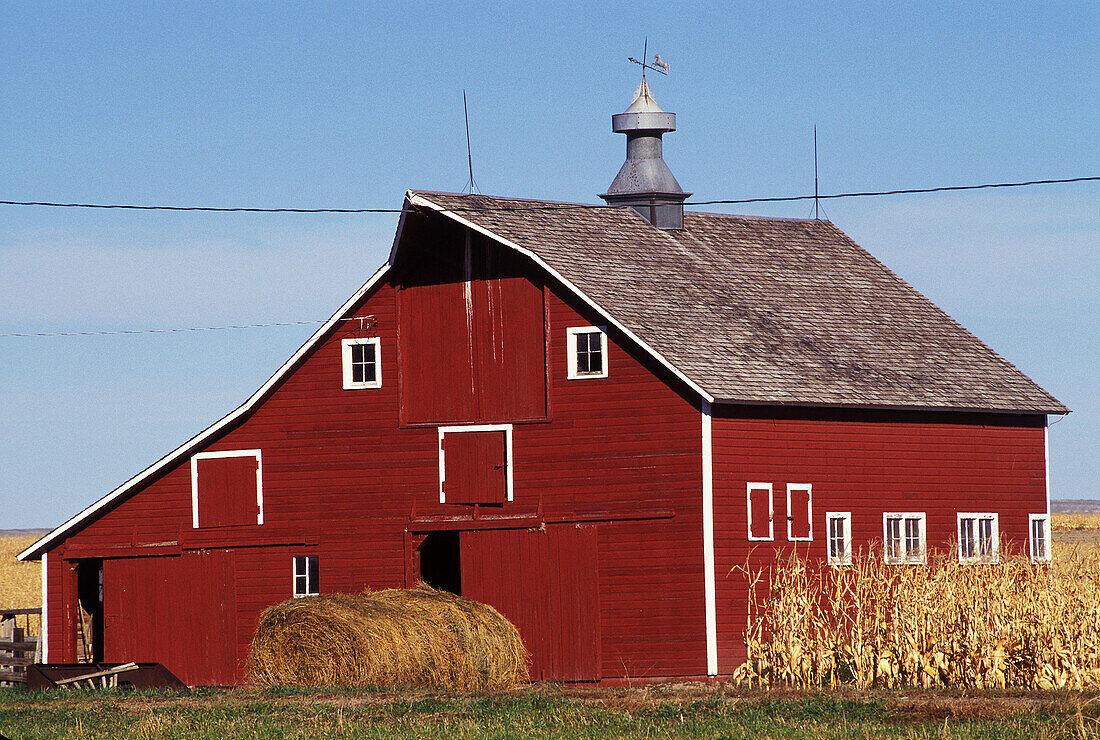 Red barn and hay bales. Western Nebraska. USA.