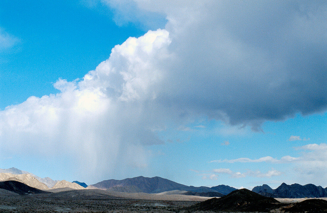 Arcing cloud and rain on desert landscape near Lake Mead National Park. USA.