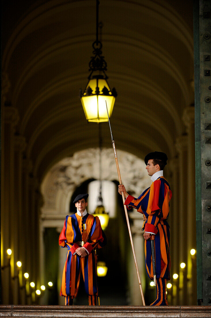 Two Swiss Guards in traditional uniforms on duty in front of the Vatican, Rome, Italy