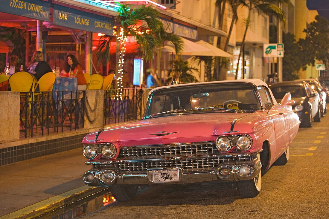 A vintage car on Collins Avenue in the evening, Miami Beach, Florida, USA