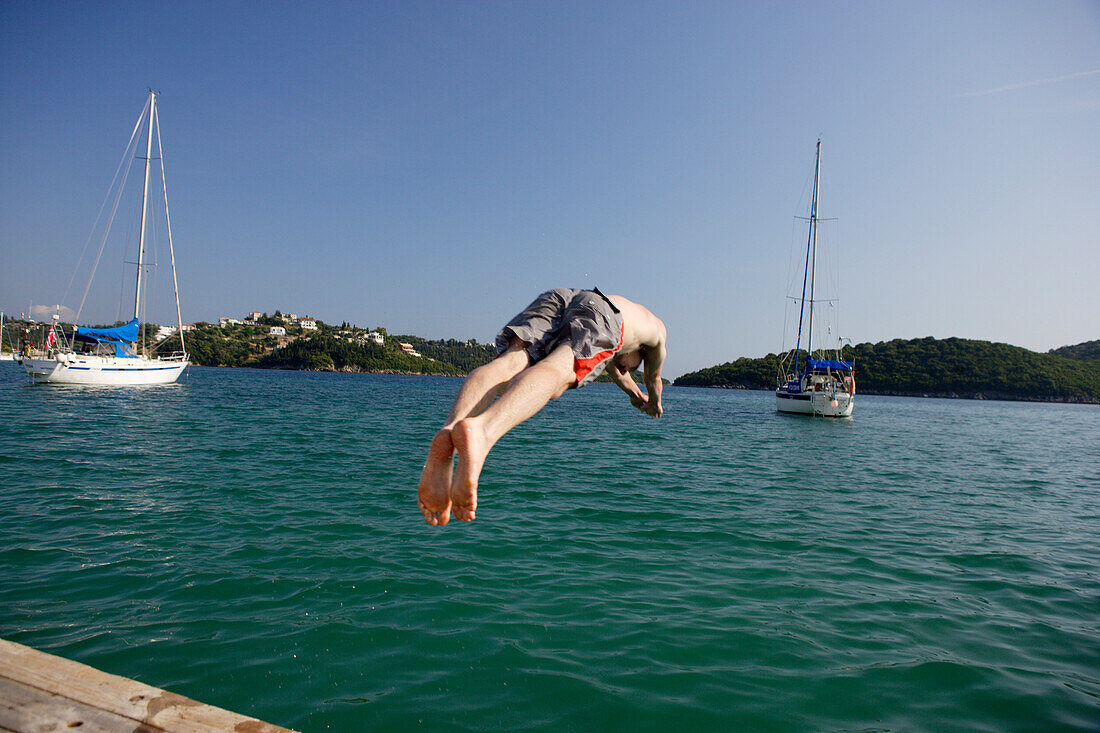 Mourtos, jumping off  the boardwalk of the marina