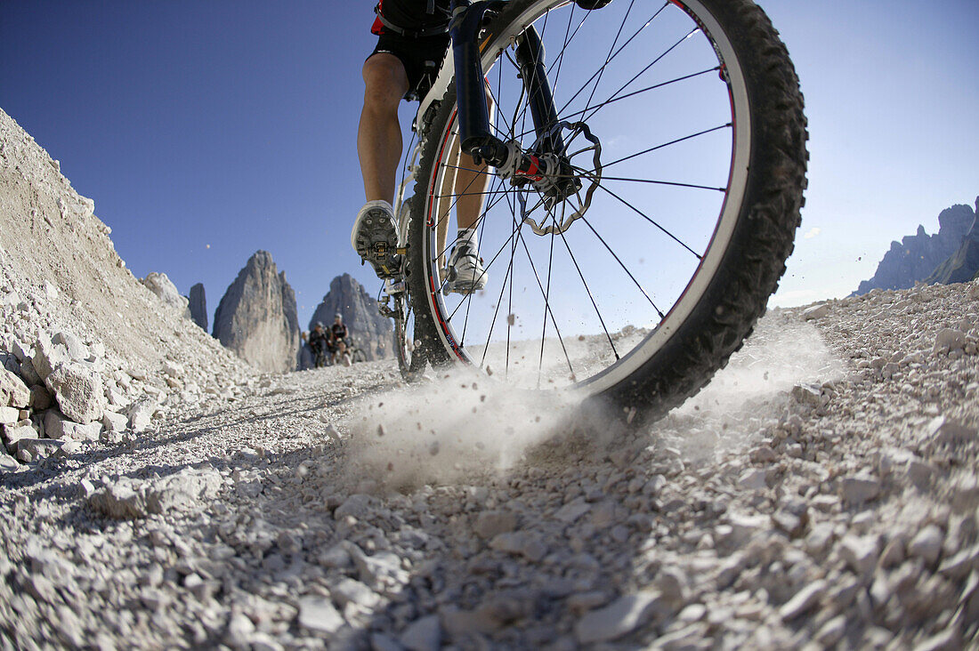 Mountain biker on mountain path, Tre Cime di Lavaredo, Dolomites, Veneto, Italy