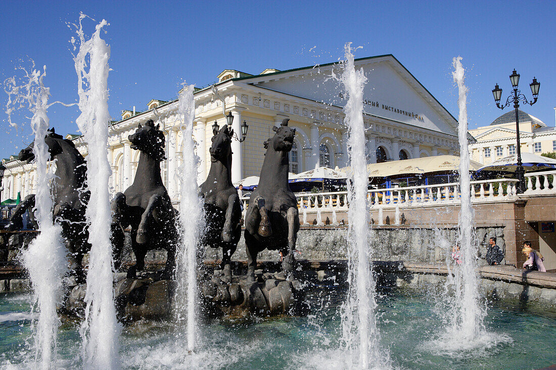 Fountain on Manege square with the Manege building, Moscow, Russia