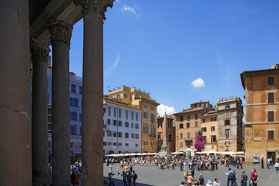 People at Piazza della Rotonda under blue sky, the columns of the Pantheon on the left, Rome, Italy, Europe