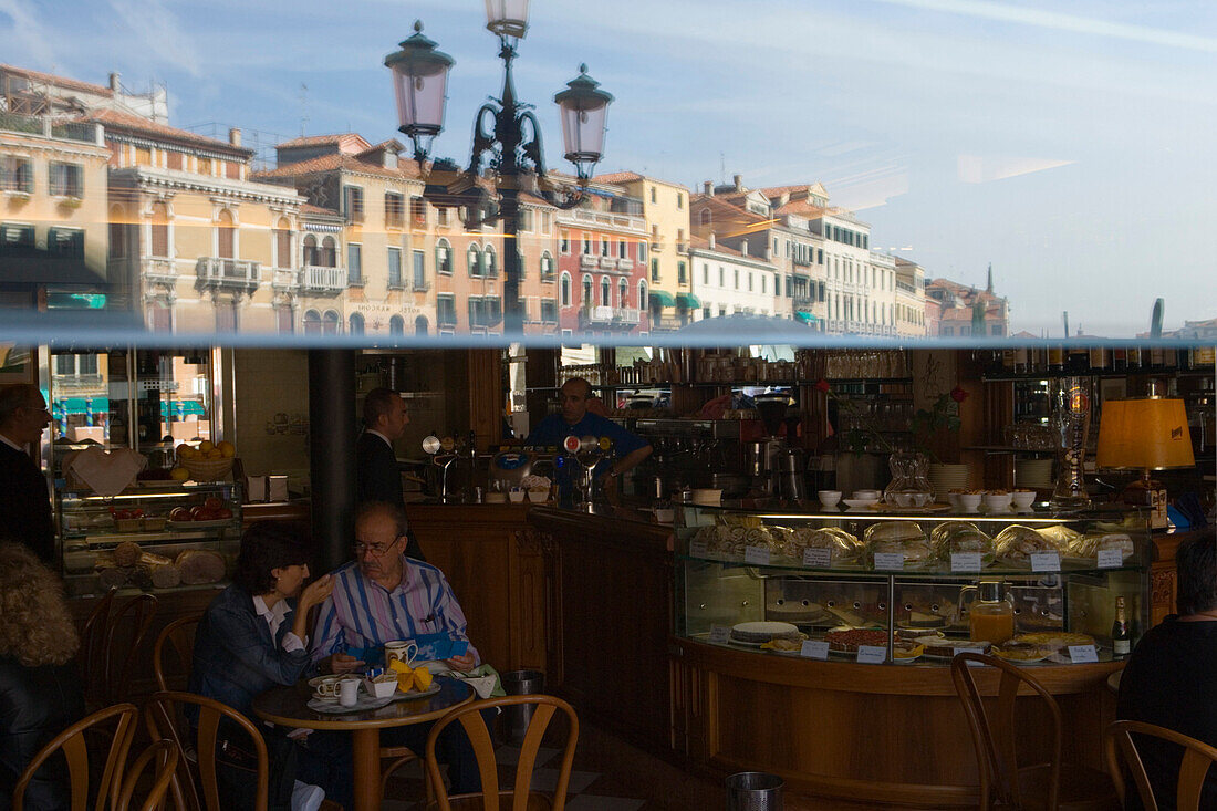 Reflection of buildings in a cafe window, near Rialto Bridge, Venice, Veneto, Italy