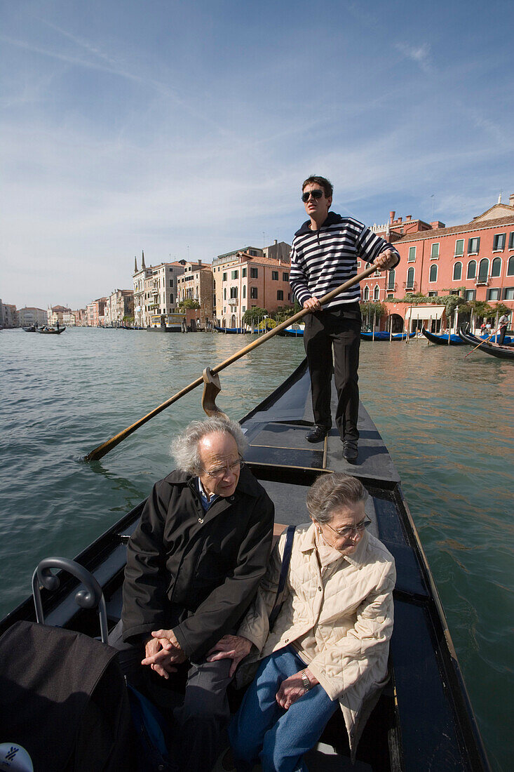 Gondolier on Gondola crossing Grand Canal near Rialto Bridge, Venice, Veneto, Italy