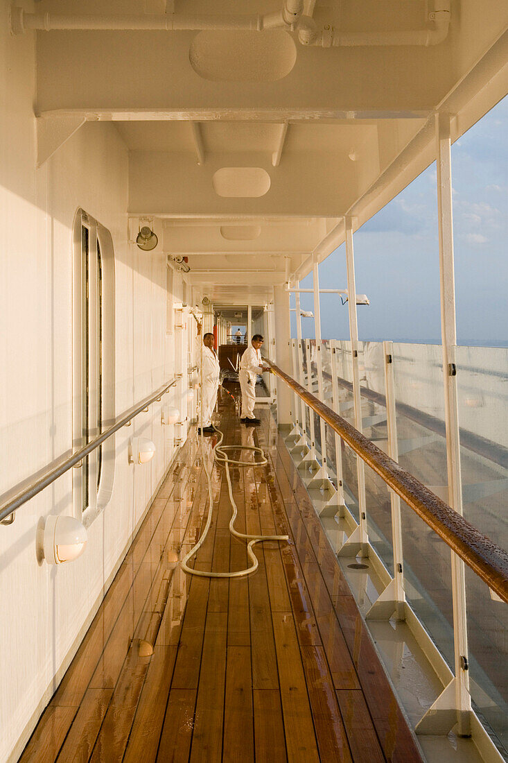 Sailors cleaning the deck on MS Europa, Atlantic Ocean, Brazil, South America