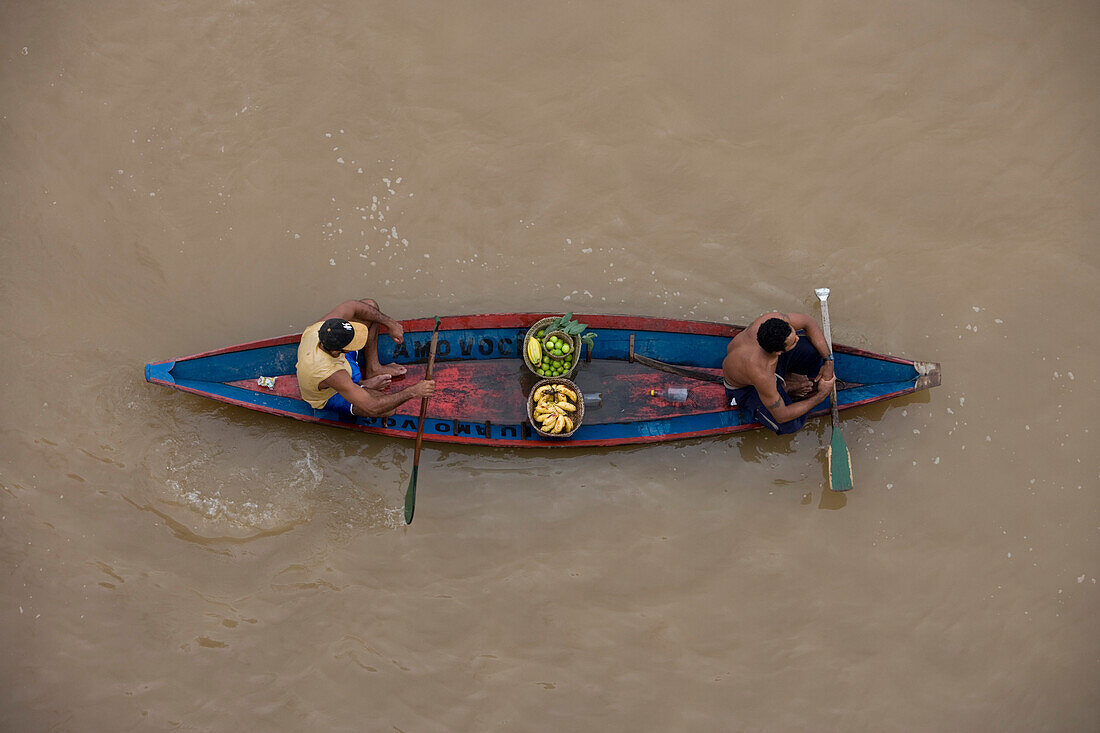 Amazonian Indians in a canoe on the Amazon River, Rio do Cajari, Para, Brazil, South America