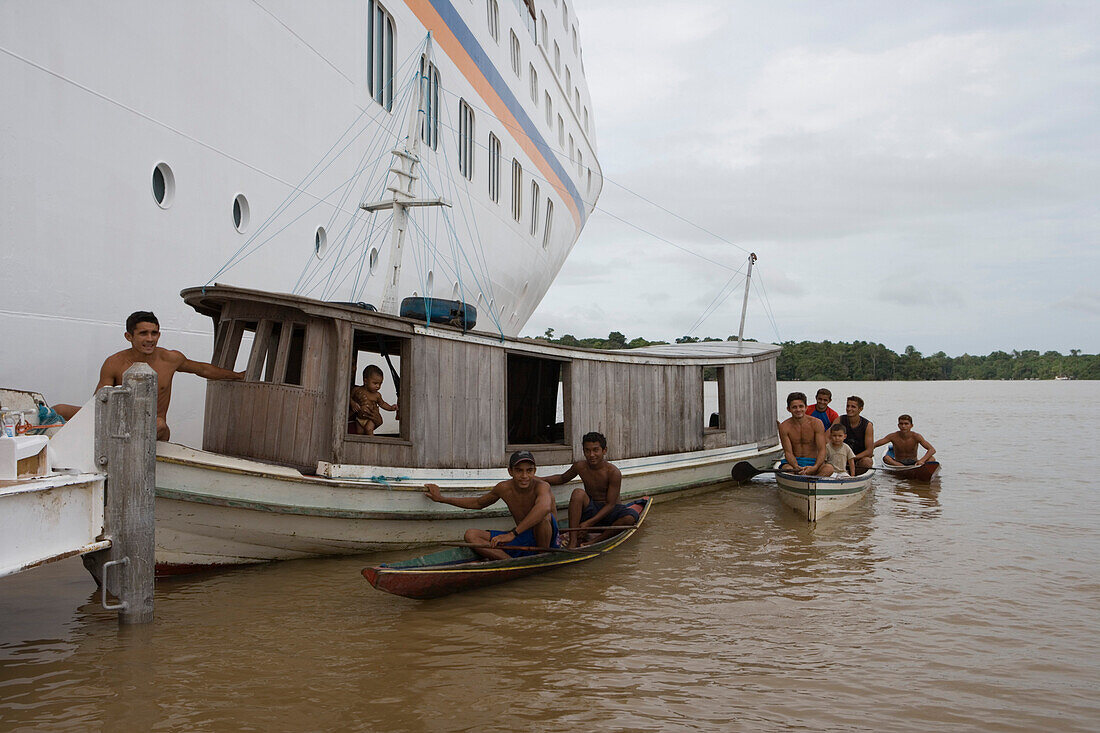 Amazonian Indians in canoes and MS Europa on the Amazon River, Rio do Cajari, Para, Brazil, South America