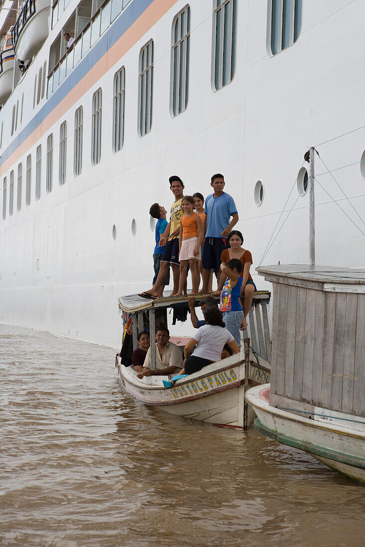 Amazonian Indians standing on a boat and the MS Europa on the Amazon River, Rio do Cajari, Para, Brazil, South America