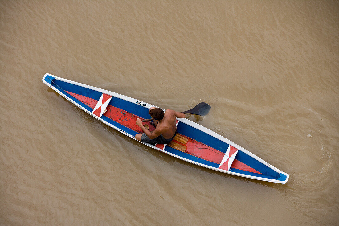 Amazon Indian man in a canoe on the Amazon River, Rio do Cajari, Para, Brazil, South America