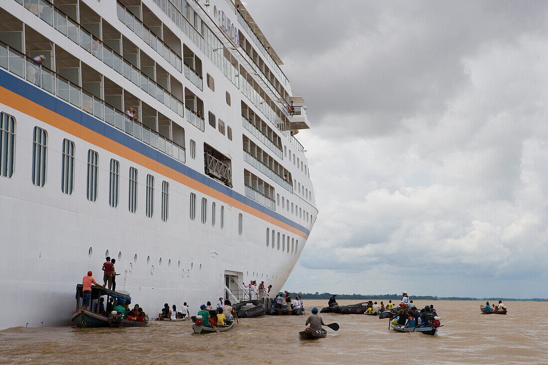 Amazonian indians in canoes and MS Europa on the Amazon River, Boca da Valeria, Amazonas, Brazil, South America