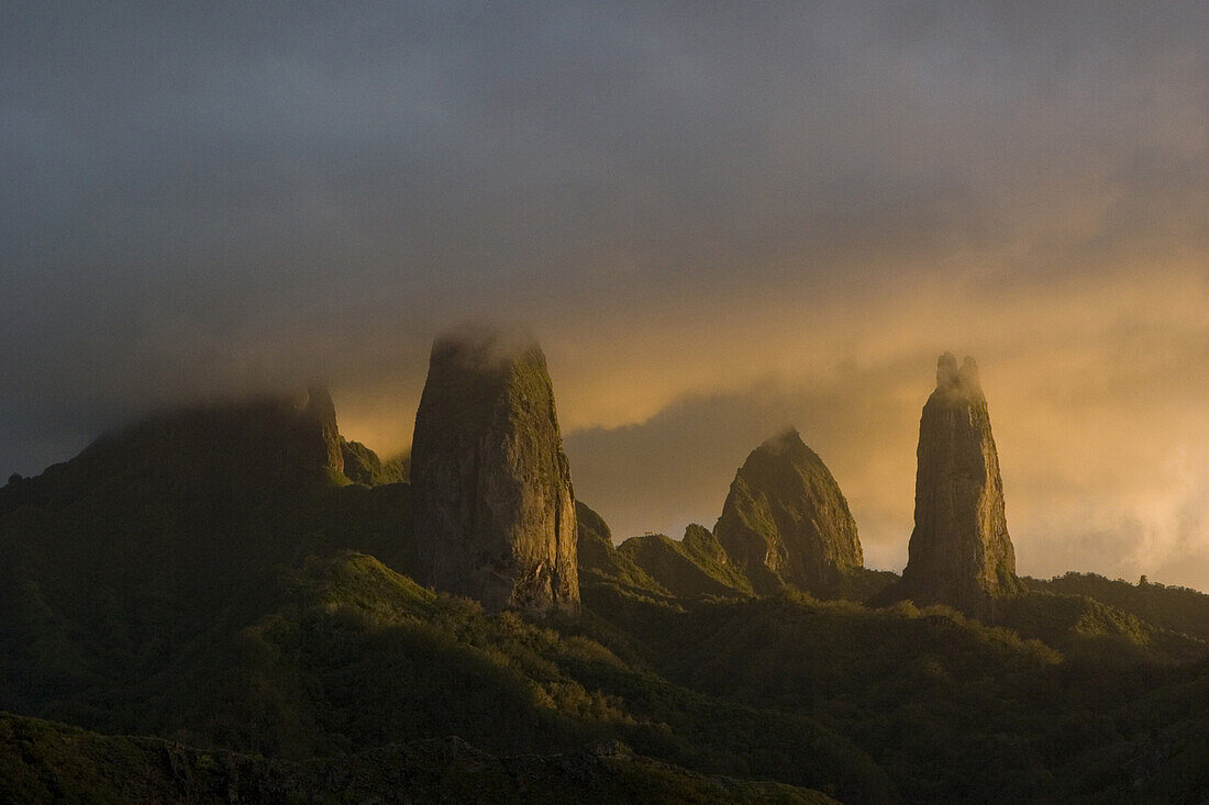 Mountain peaks of Ua Pou under cloud cover in the evening light, Marquesas, Polynesia, Oceania