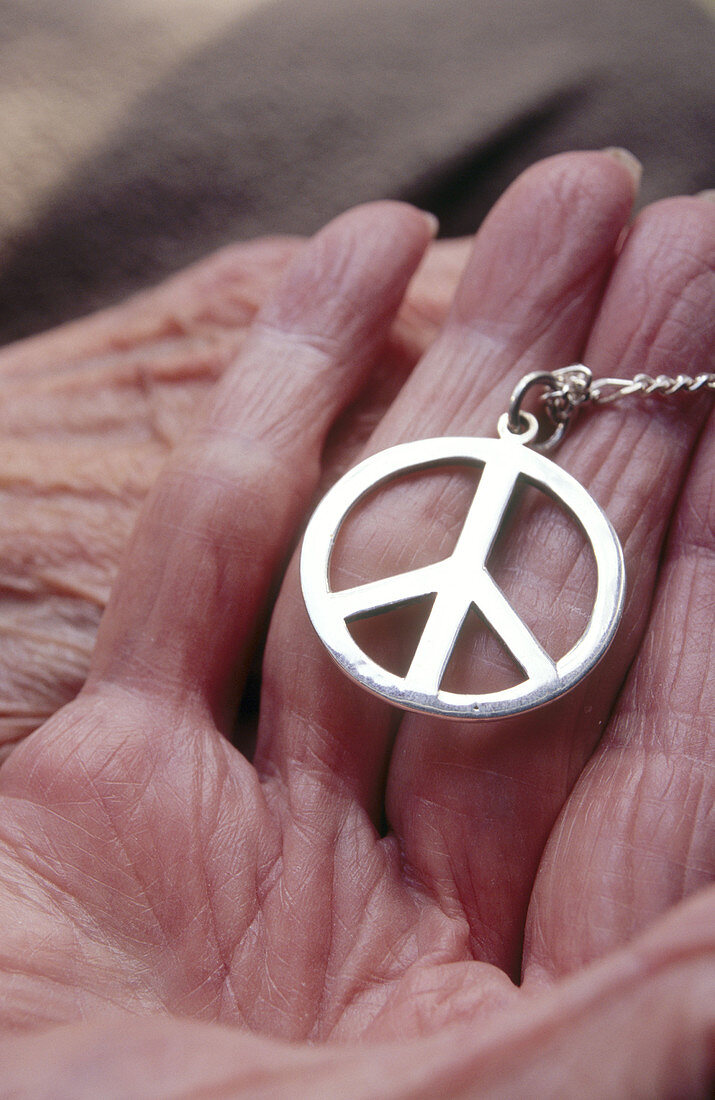 Peace symbol in hand of old person