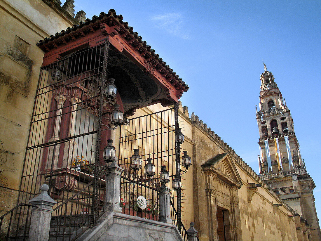 Virgen de los faroles with Torre Catedralicia of the Great Mosque of Cordoba at background. Andalusia, Spain