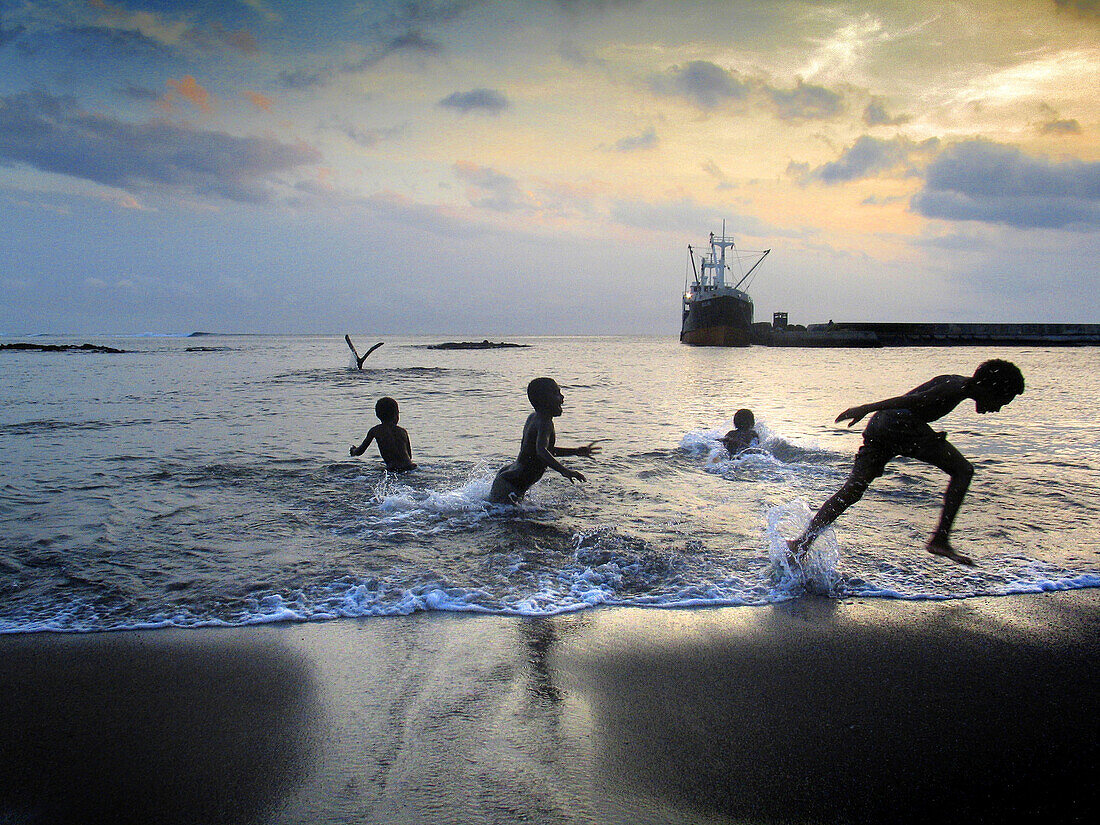 Children playing on beach by the port of Ipikel. Tanna, Vanuatu