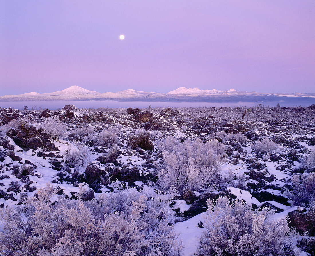 Moon over Lava Lands. Mount Bachelor and Three Sisters in Winter. Newberry National Volcanic Monument. Deschutes National Forest. Oregon. USA