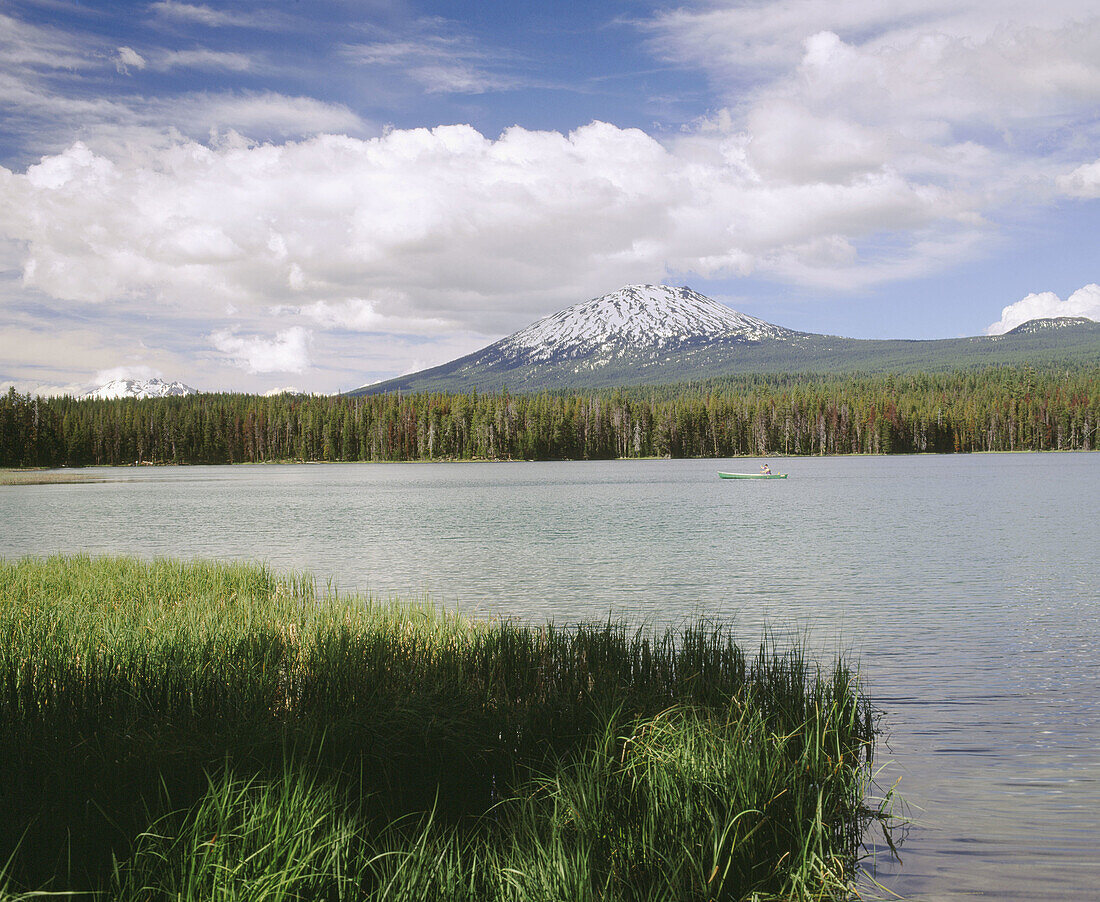 Lone canoe on Little lava lake with Mt. Bachelor at background. Deschutes National Forest. Oregon. USA