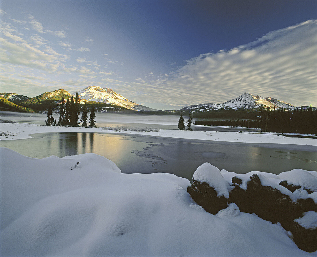 Sunrise on South Sister and Broken Top from Sparks Lake after fall snowstorm. Deschutes National Forest, Deschutes County. Oregon. USA.