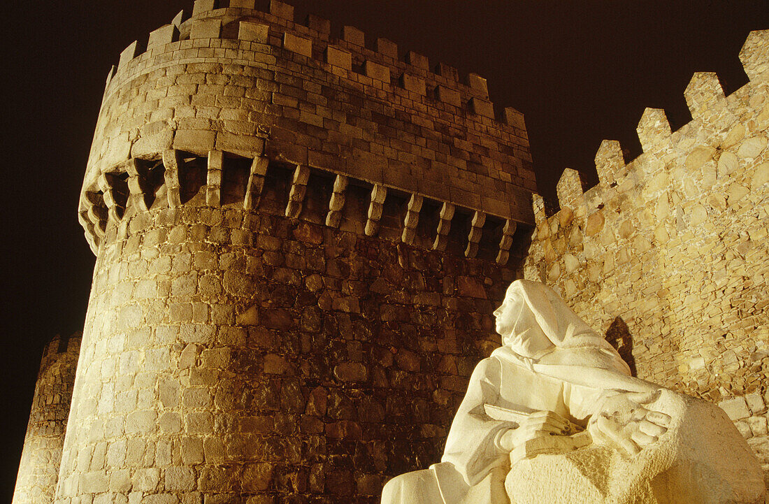 Medieval walls and sculpture of Santa Teresa de Jesus. Avila. Castilla y Leon. Spain