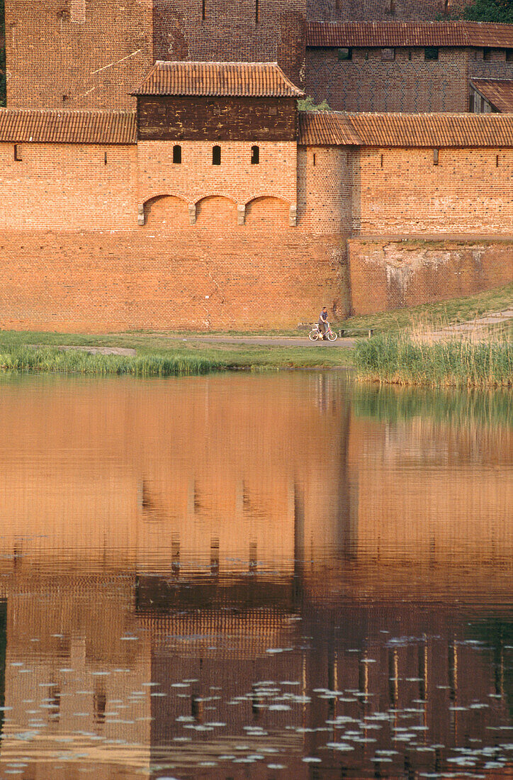 Europe s largest gothic castle (13th century), residence of Teutonic Knights grand master, reflection on the Vistula River Delta known as the Nogat. Malbork. Pomerania, Poland