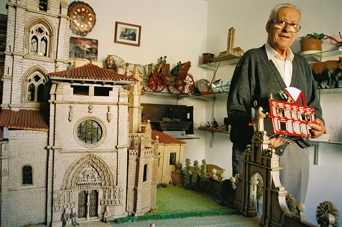 Mr. Néctor Calzada and his old farm implement miniature collection that he shows in his own home. Sasamón. Burgos province, Spain