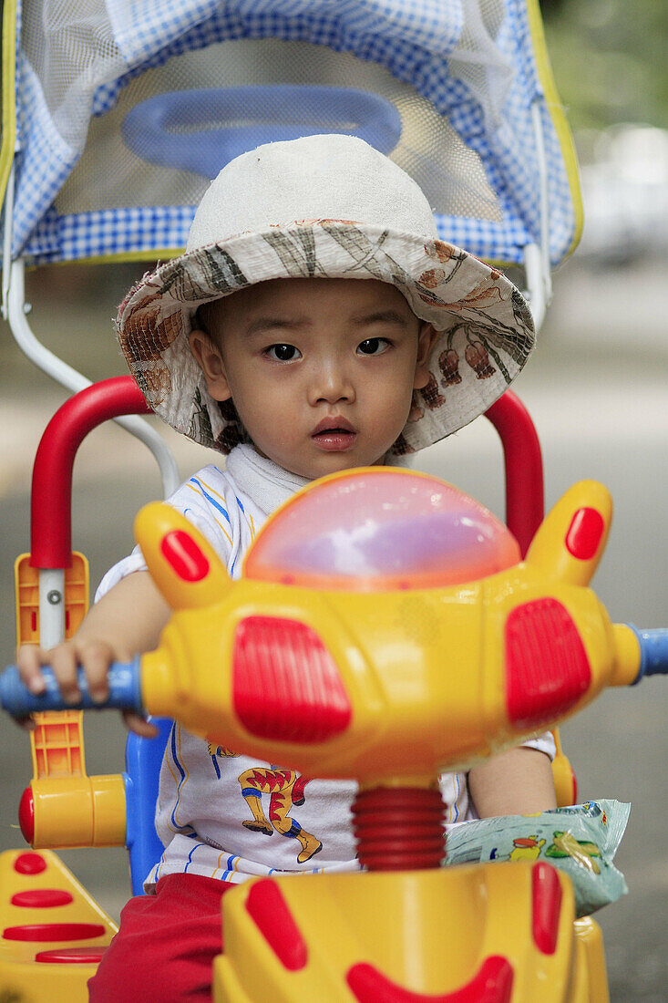 Portrait of a baby girl. Front view. The Old Quarter, Hanoi, Vietnam, Indochina, Southeast Asia, Asia 2006