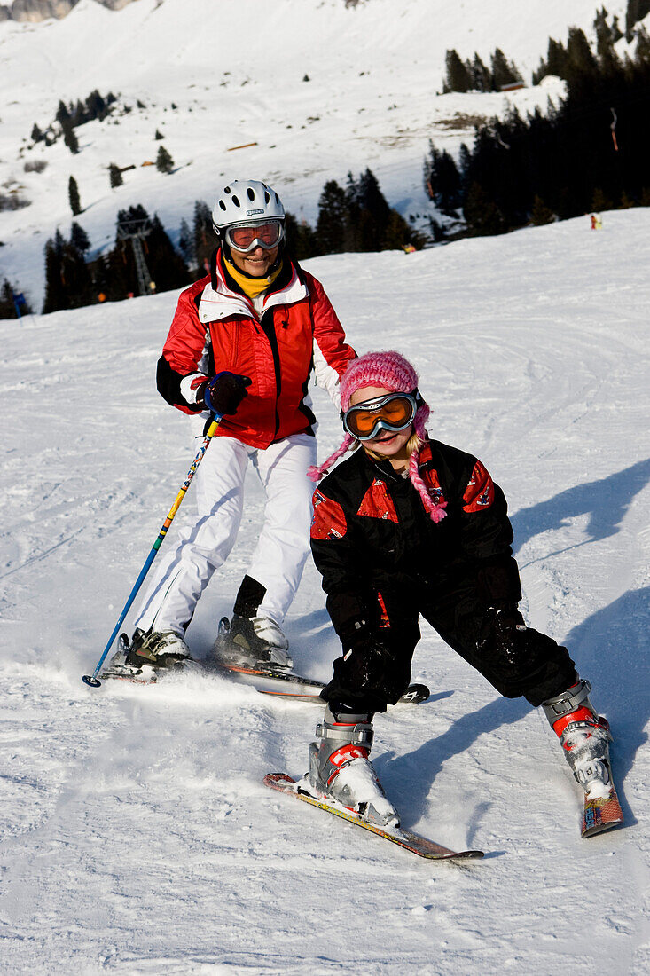 A little girl and her grandmother skiing at Flims, Graubünden, Switzerland