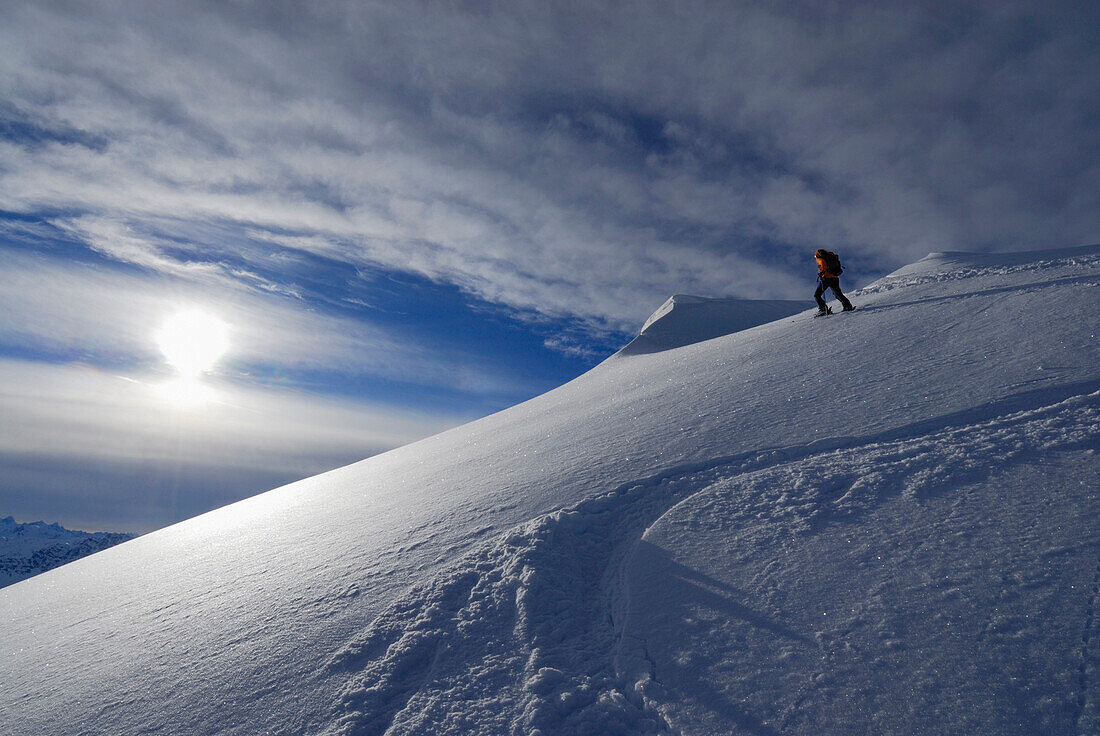 Female backcountry skier on ridge with cornices, Allgaeu Alps, Tyrol, Austria