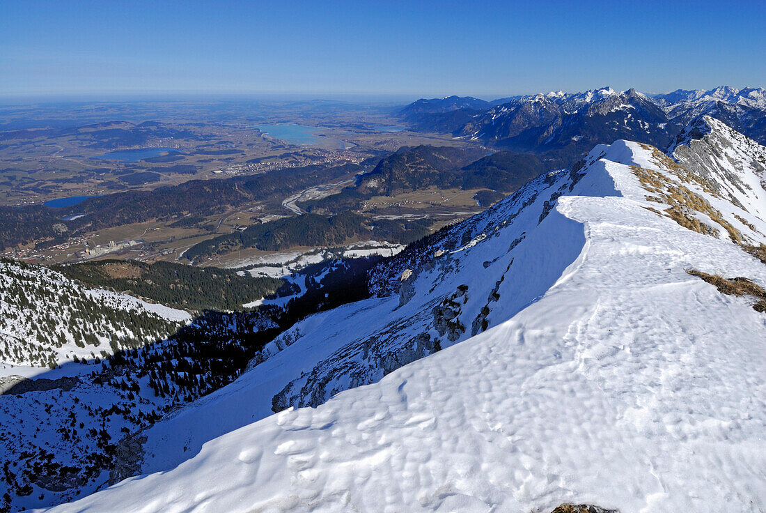 view from snow-covered summit of Große Schlicke to lake Weißensee, Hopfensee, Forggensee and Bannwaldsee, Tannheim range, Allgaeu range, Allgaeu, Tyrol, Austria