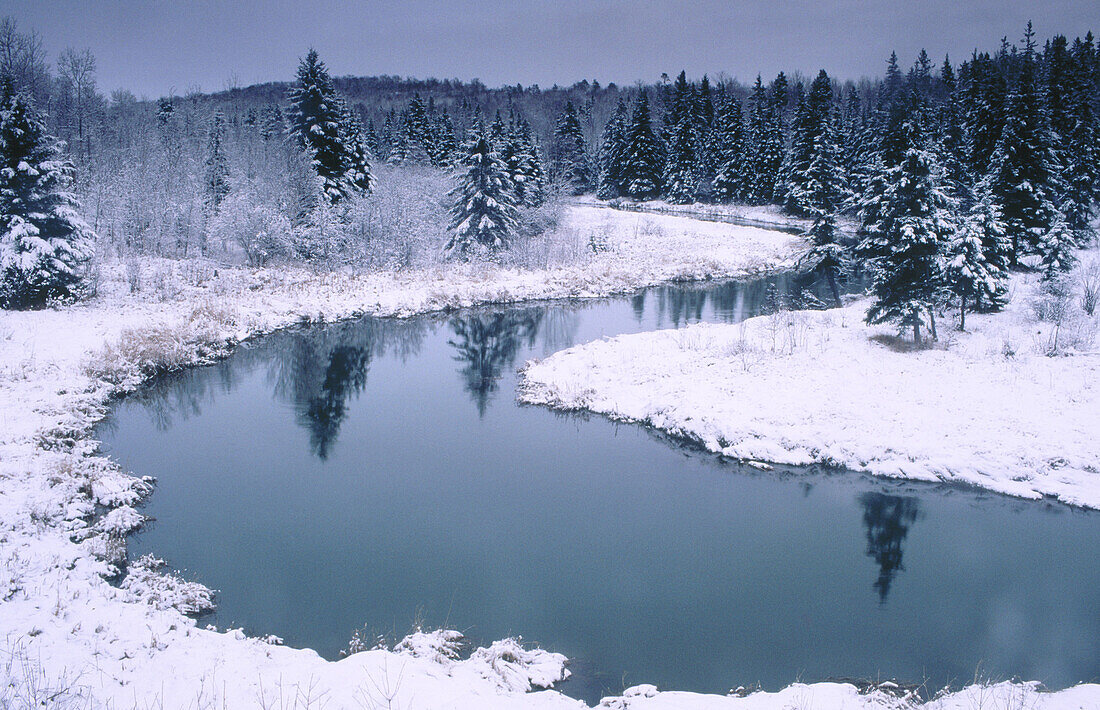 Curve of Junction creek with fresh snow on shoreline. Walden. Ontario. Canada