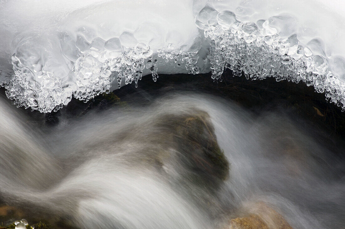 Ice formations and running water at O Shaughnessy Creek. Alberta, Canada