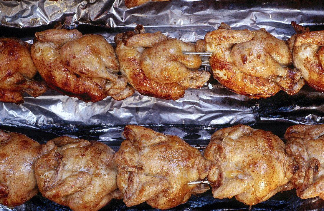 Whole chickens on a rôtisserie (grill restaurant). France