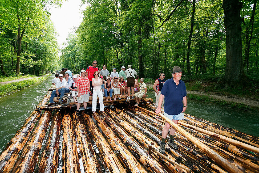 Group of tourists on wooden raft on river Isar, Upper Bavaria, Bavaria, Germany