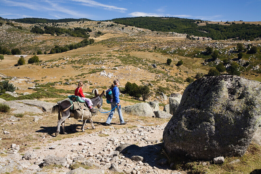 Mother and child on a hiking tour, Family hiking trip with a donkey in the Cevennes mountains, Cevennen, France