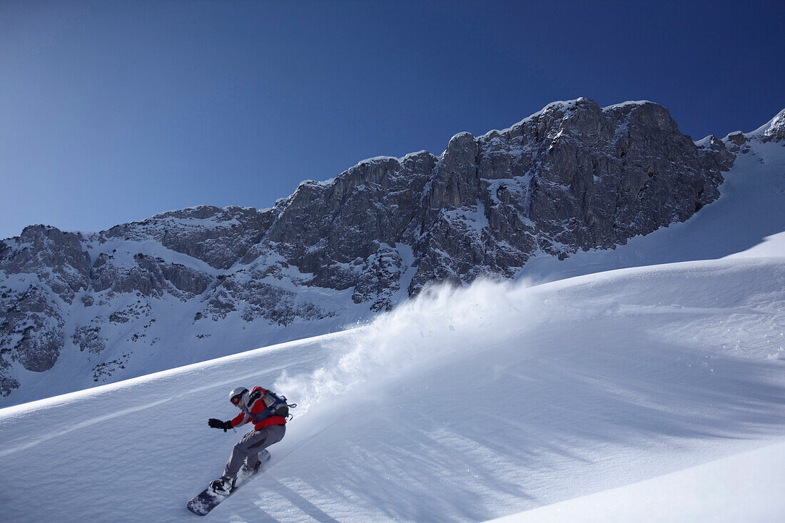 Snowboarder on slope, Reutte, Tyrol, Austria