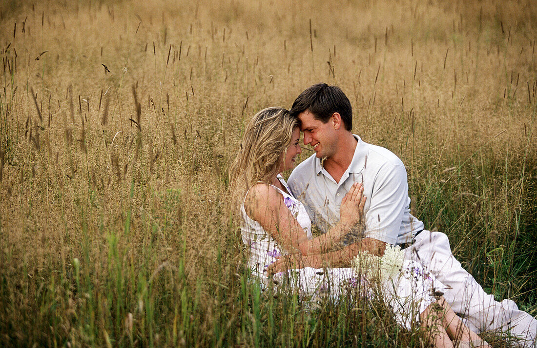 Couple hugging in a field