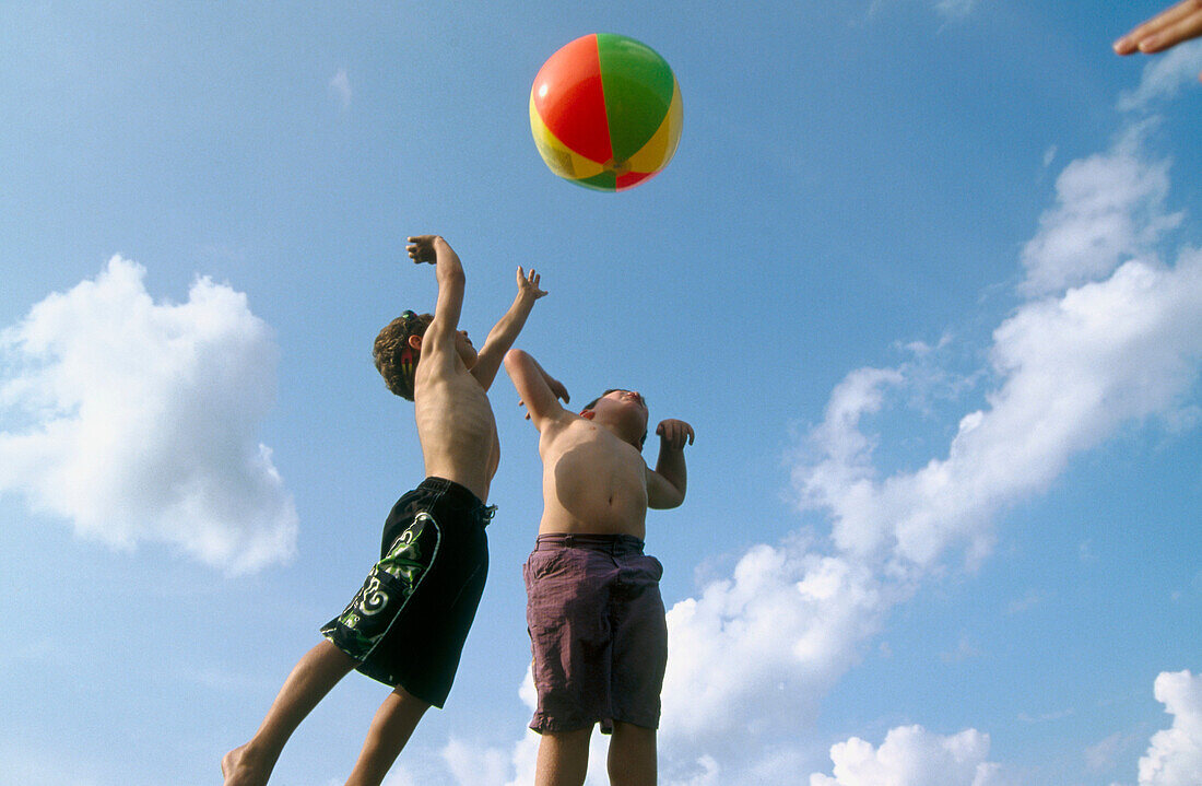 young boys playing beach ball