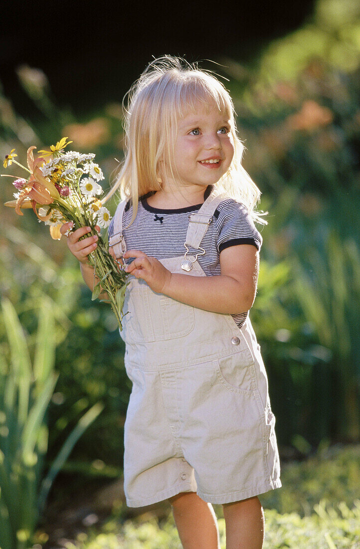 Little girl picking flowers