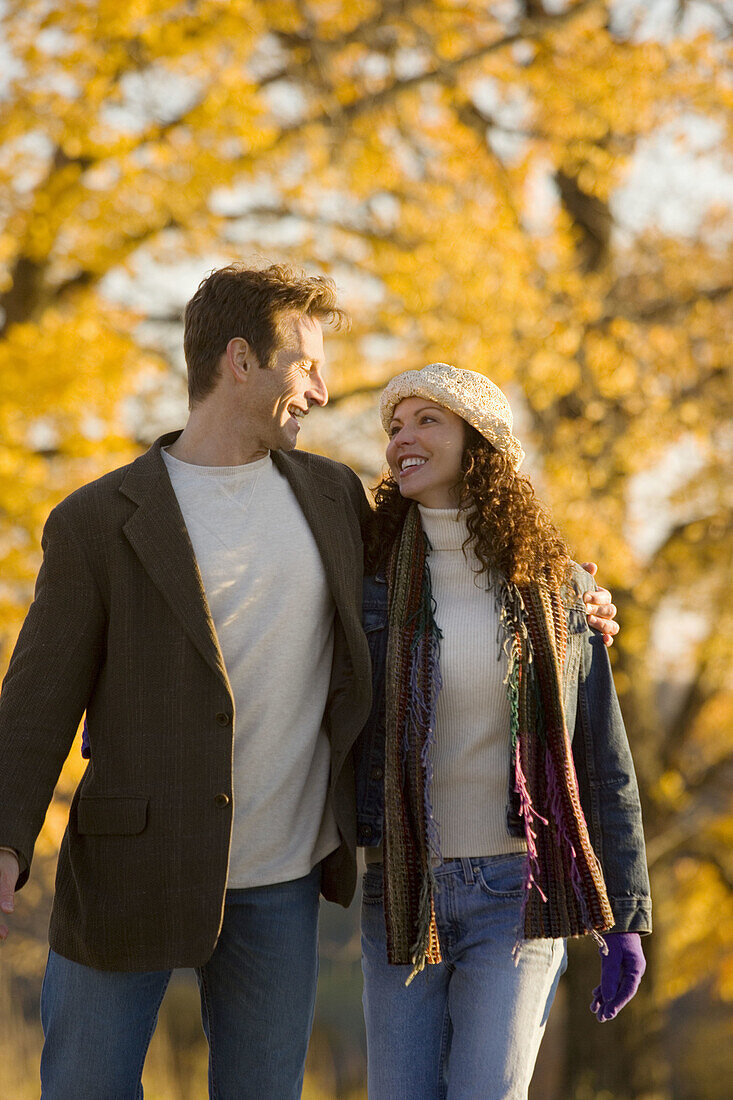 Couple smiling and walking in the country