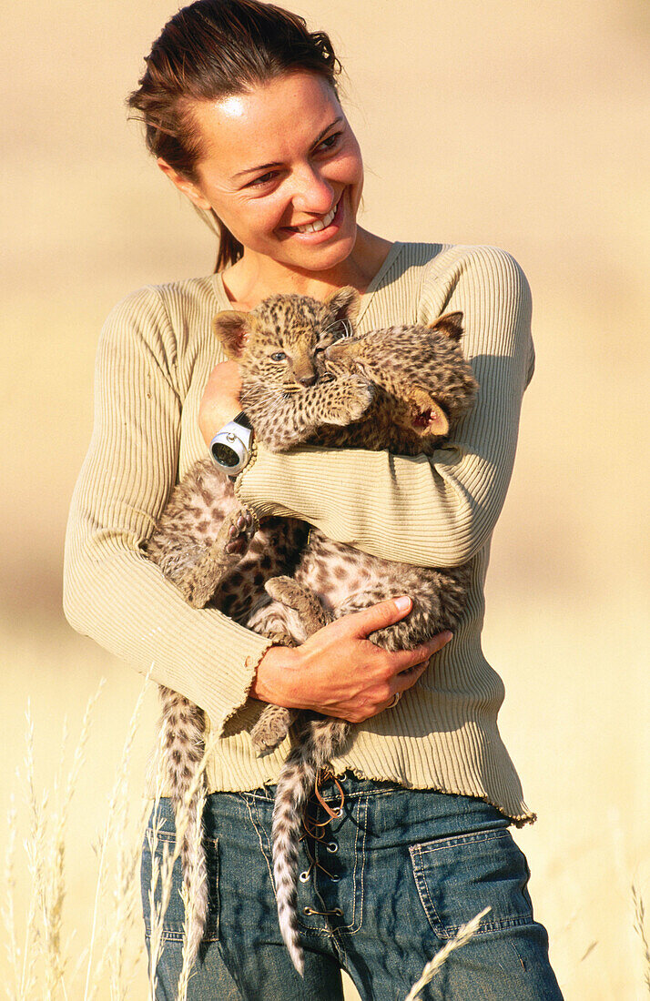 Woman with young leopards. Namibia