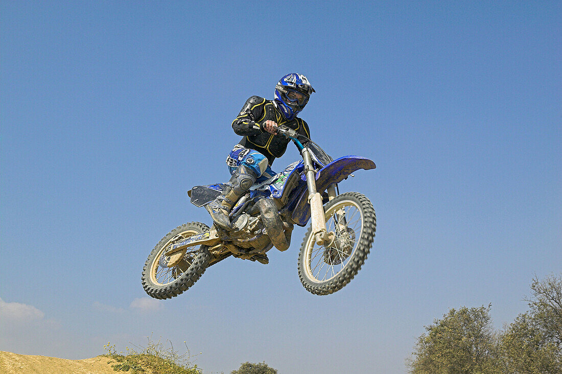 Enduro motorcyclist jumping.