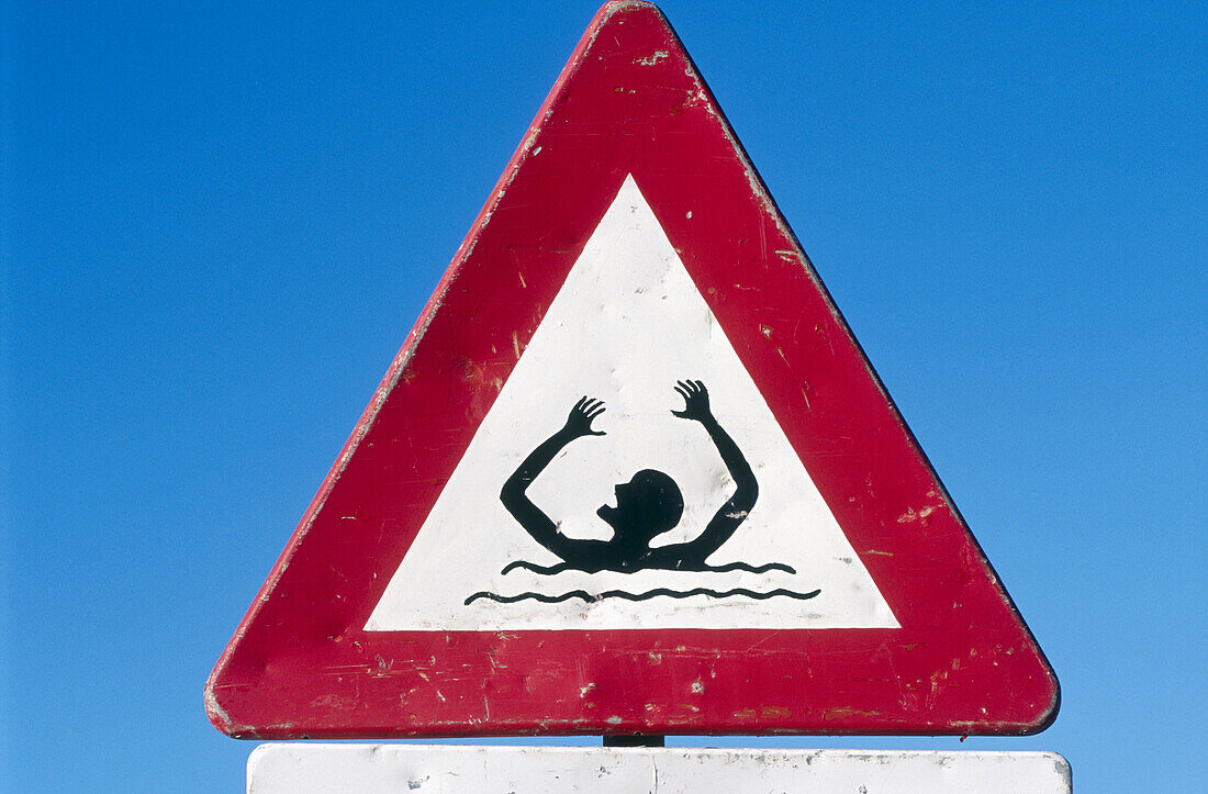 Warning sign on beach. Texel island, Holland