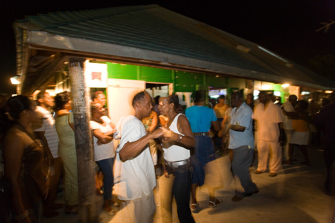 Couple Dancing at  Friday Market at night, Oistins, Barbados, Caribbean