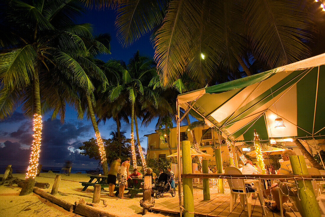 Guests in the Carib Beach Bar in the evening, Barbados, Caribbean