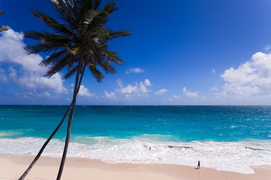 Person standing in spray of Atlantic Ocean at Bottom Bay, St. Philip, Barbados, Caribbean
