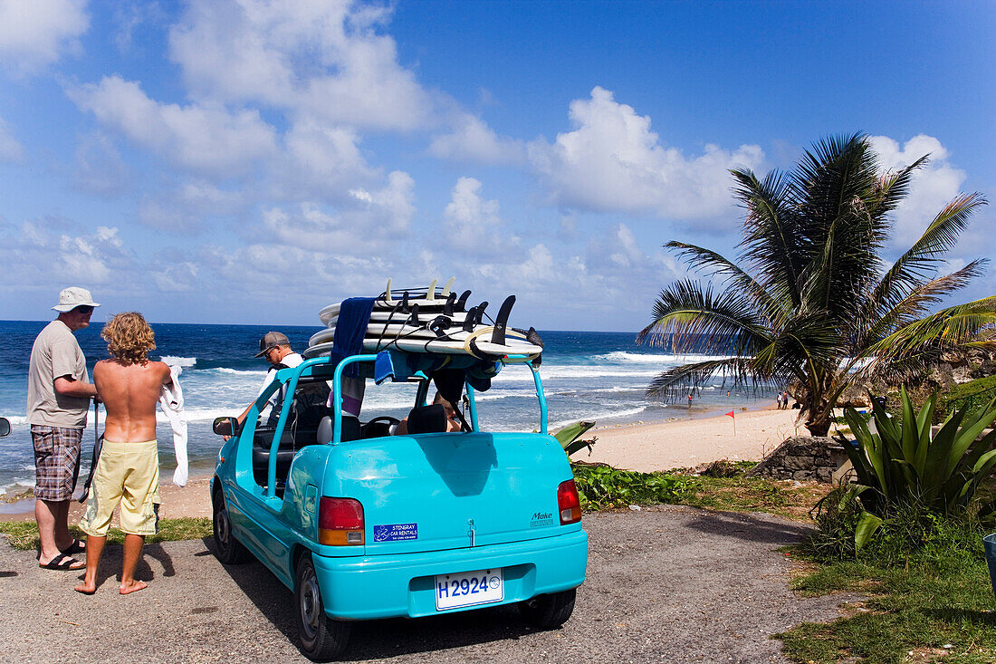 Three men near a car with surfboards, Bathsheba, Barbados, Caribbean