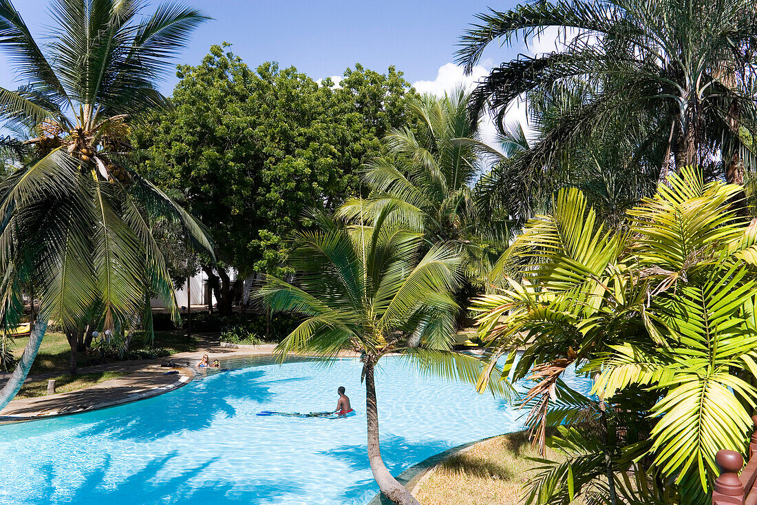 Guests bathing in the swimming pool, Sarova Whitesands Beach Resort and Spa, Shanzu Beach, Coast, Kenya